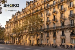 Grand Haussmann apartment building in Paris at golden hour reflecting political stability and long-term real estate value